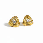 A pair of gold-toned triangular stud earrings with a braided knot design, accented with small clear crystals and a larger round crystal in the center of each earring, shown on a plain white background.