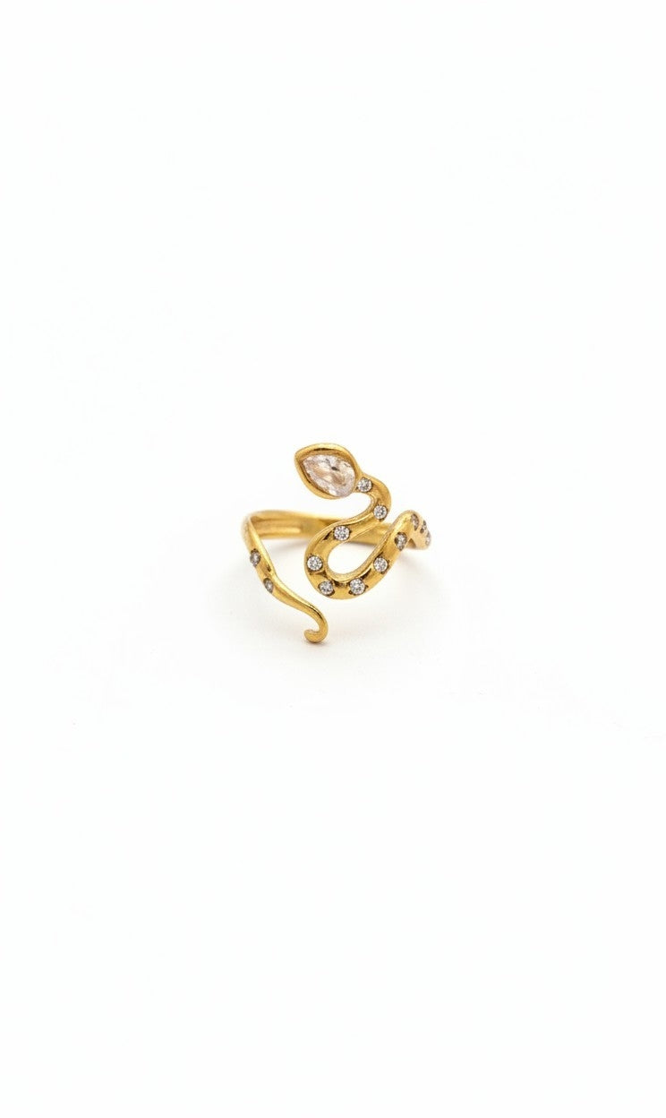 A gold snake-shaped ring with small clear gemstones, photographed on a plain white background.
Grishita Jewellery