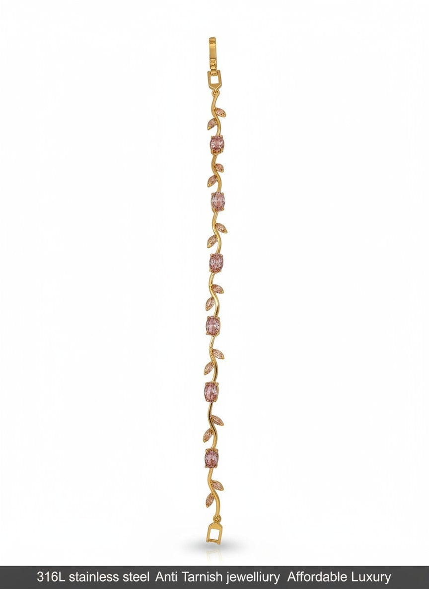 A delicate gold-toned vine bracelet featuring small pink gemstone accents, displayed vertically against a plain white background with a black text banner at the bottom.
Grishita Jewellery