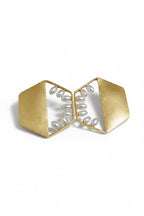 A pair of gold geometric statement earrings with white freshwater pearls arranged in a curved line inside open triangular frames, set against a plain white background.