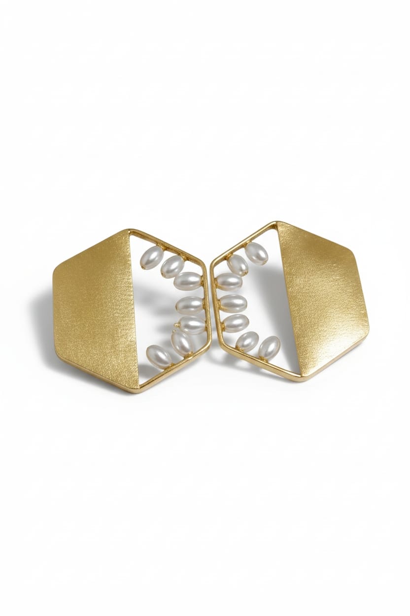A pair of gold geometric statement earrings with white freshwater pearls arranged in a curved line inside open triangular frames, set against a plain white background.